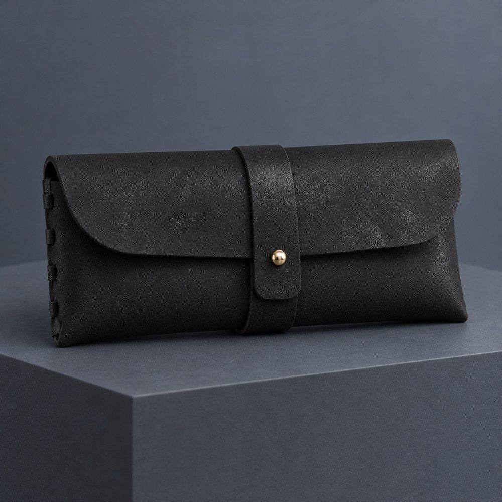 Black custom soft eyeglass case with a gold YOUR LOGO placeholder to the left of the wrap strap, illustrating logo placement.