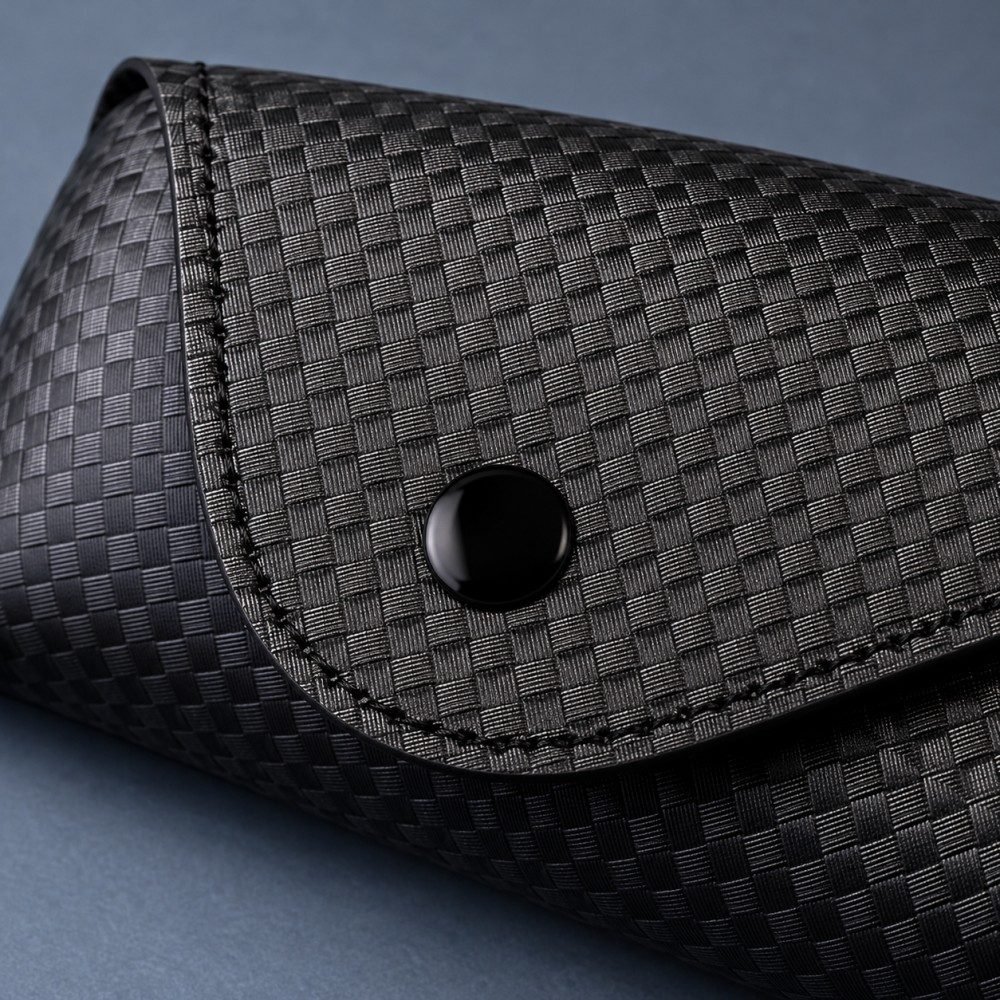Close-up of the embossed texture, stitched flap and black snap fastening