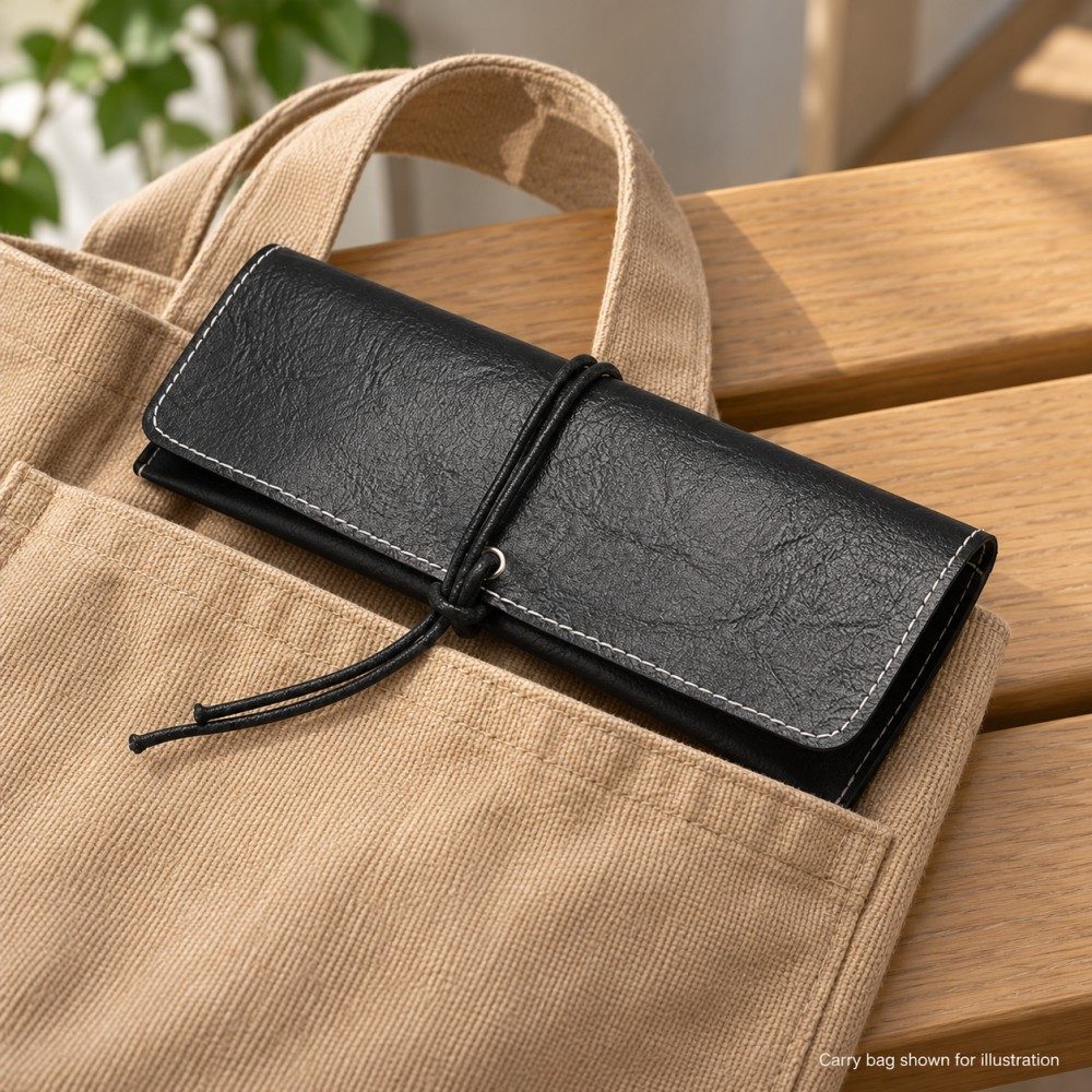 Black wrap-cord glasses case partly tucked into a tan tote pocket on a wooden bench, with the bag shown for illustration.
