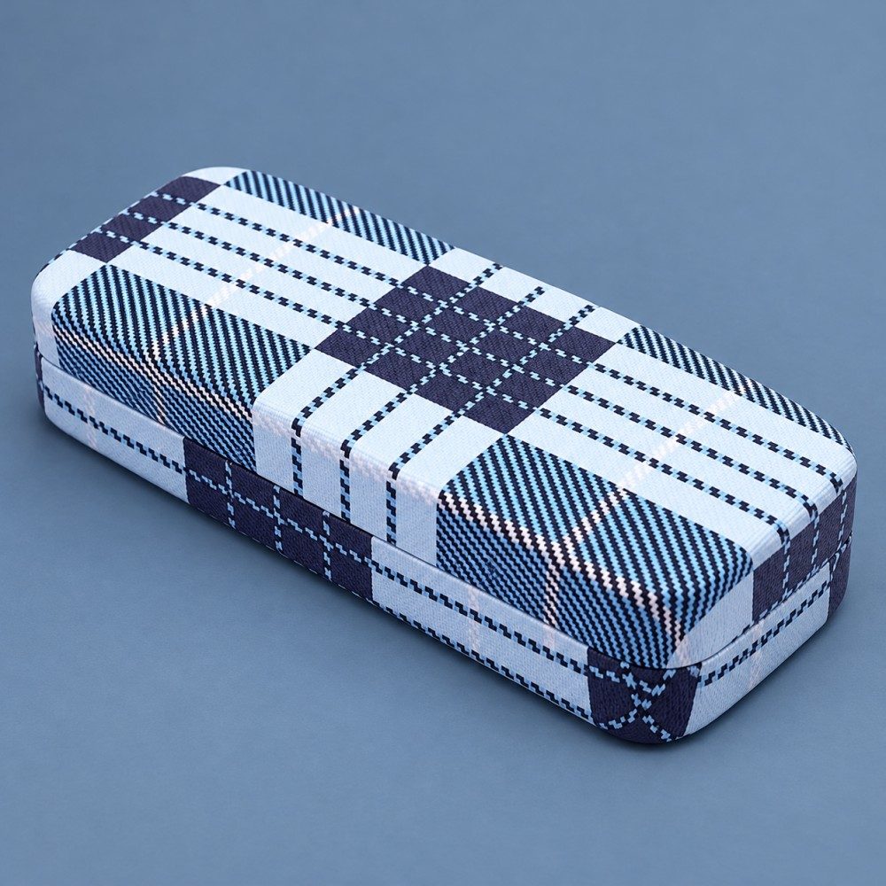 Closed blue and navy plaid metal eyeglass case with rounded corners on a muted blue background.