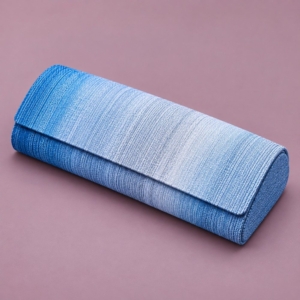 Blue and silver gradient handmade eyeglass case with a textured rectangular flap and rounded ends on a muted mauve background.