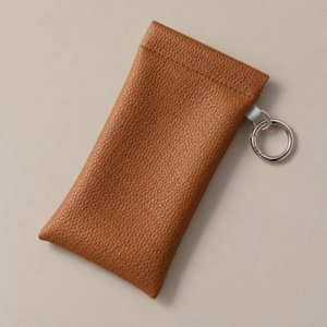 Taupe PU leather glasses pouch showing the squeeze-top opening with sunglasses