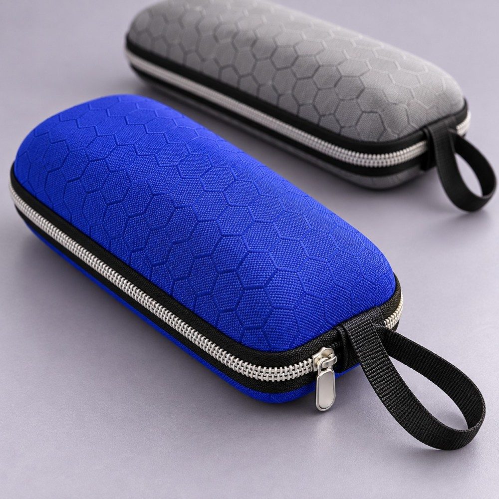 Close-up of honeycomb fabric, zipper and woven wrist loop on a blue EVA sunglasses case