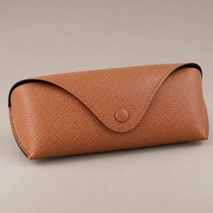 Brown YX12 glasses case with reference dimension labels of 16.3 cm and 6.2 cm on a sage background.