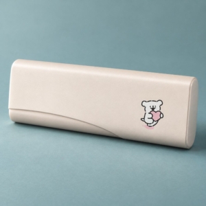 Cream cartoon metal glasses case with a bear illustration and curved front detail