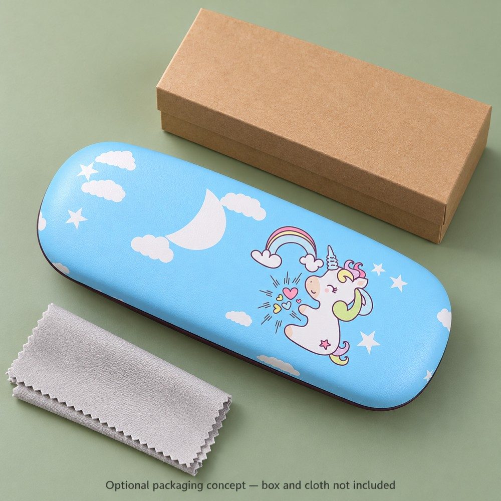 Blue unicorn eyeglass case beside round eyeglasses on a wooden study desk with a notebook and pencil.