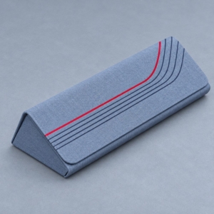 Blue custom magnetic glasses case with a triangular profile, textured finish and curved red and navy stripes.