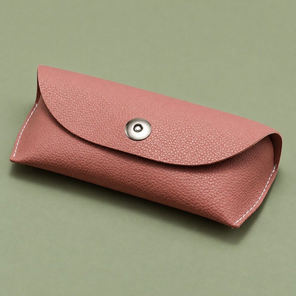 Pink soft glasses case with a rounded flap and central silver-tone fastener