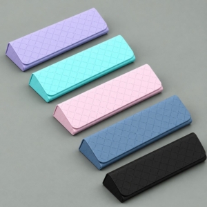 Five diamond-pattern glasses cases in lavender, mint cyan, pale pink, slate blue and black on a gray-green background.
