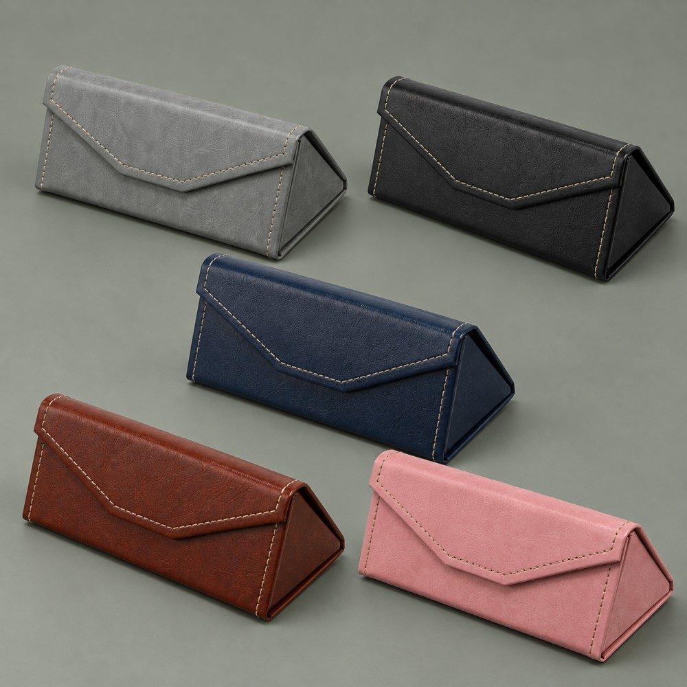 Five triangular foldable glasses cases in grey, black, deep navy, dark brown and pink with matching contrast stitching.