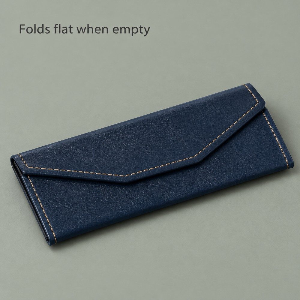 Empty navy glasses case collapsed into a flat envelope shape with a stitched magnetic flap.
