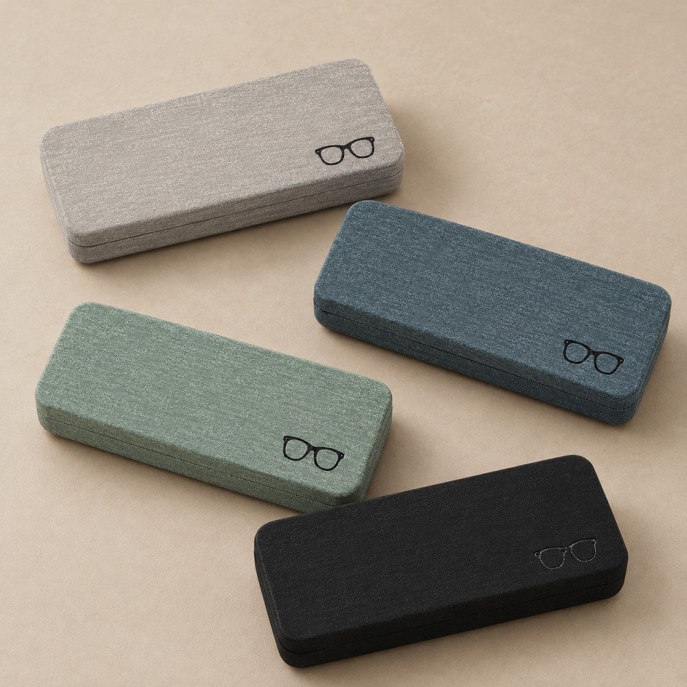 Four textured glasses cases in gray, gray-blue, pale green and black with matching rectangular shapes.