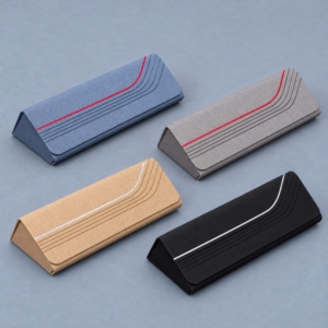 Blue, grey, beige and black magnetic glasses cases with matching curved stripe designs and triangular profiles.