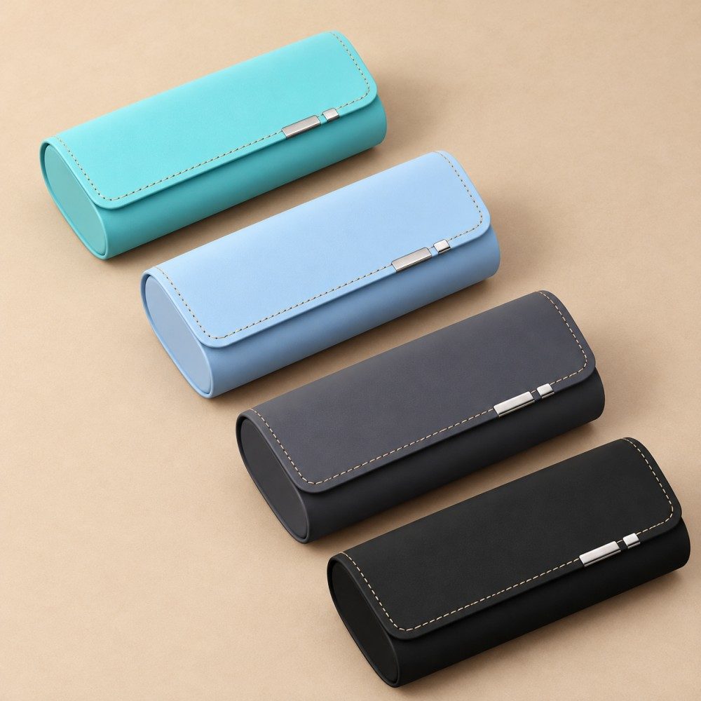Four matching magnetic flap glasses cases in turquoise, light blue, charcoal grey and black with silver-tone edge accents.