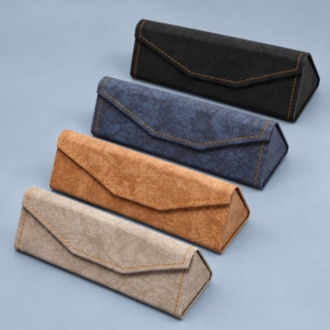 Four PU leather folding glasses cases in black, navy blue, coffee brown and milk-tea taupe with matching contrast stitching.