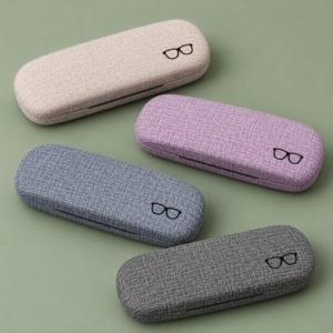 Four rounded PU glasses cases in beige, lavender, blue-gray and dark gray on a muted green background.