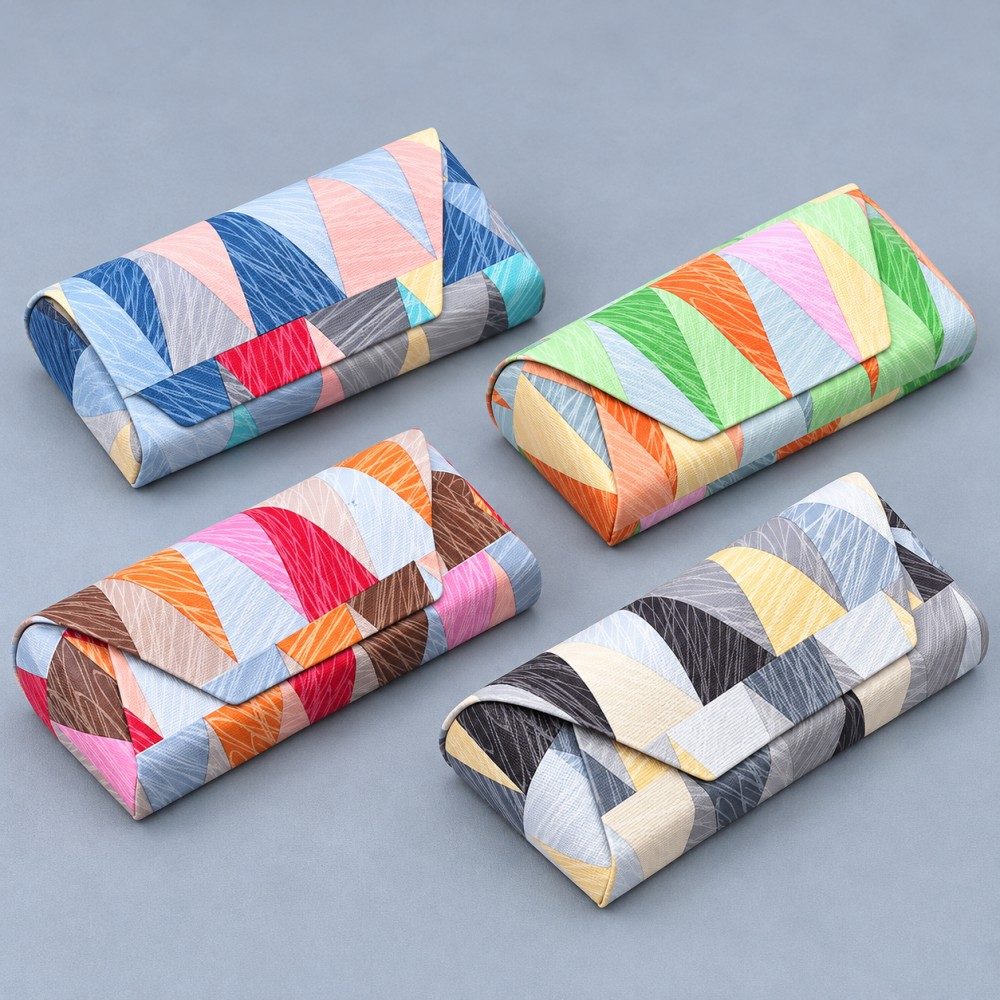 Four geometric print magnetic glasses cases in blue, green, brown and charcoal color combinations.