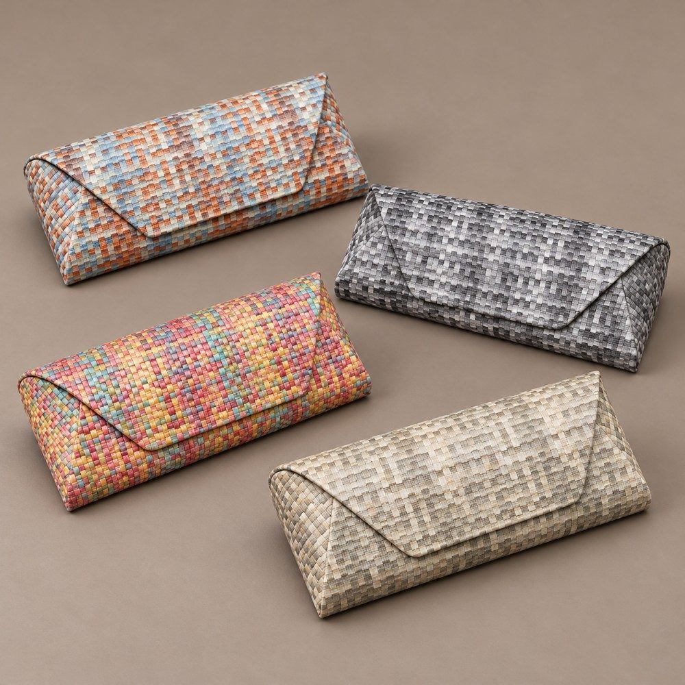 Four envelope-style glasses cases in gray, cream-beige, blue-rust and bright multicolor patterns.