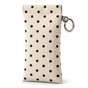 Ivory squeeze top eyeglass pouch with black polka dots and a silver clip ring