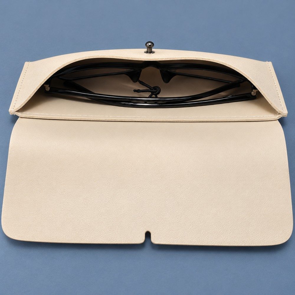 Open ivory eyeglass case showing a folded pair of dark glasses inside and the flap laid forward.