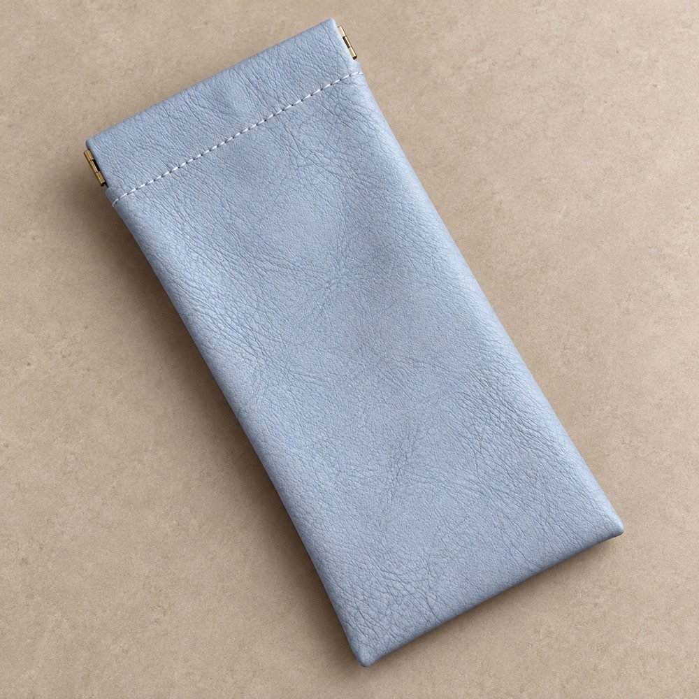 Blue gray squeeze top glasses pouch with a textured exterior and stitched opening