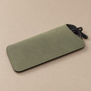 Close-up of the curved opening and black flocked lining inside a PVC glasses pouch