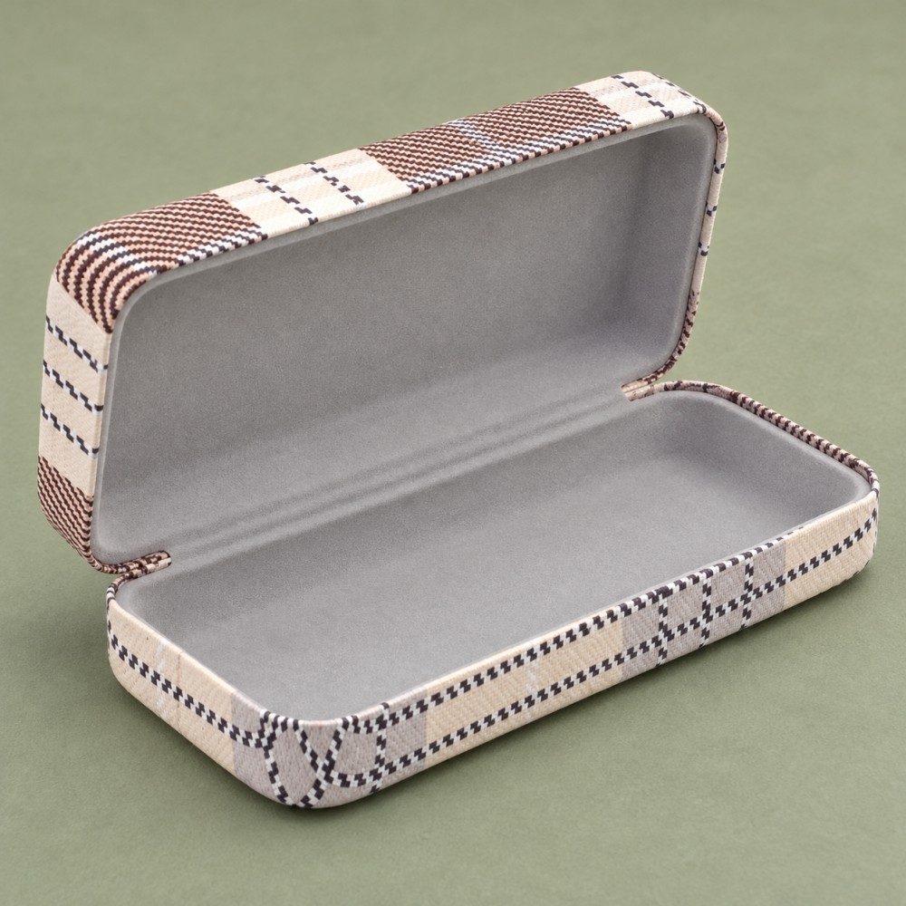Open cream and brown plaid eyeglass case showing gray flocked lining inside the hinged lid and base.