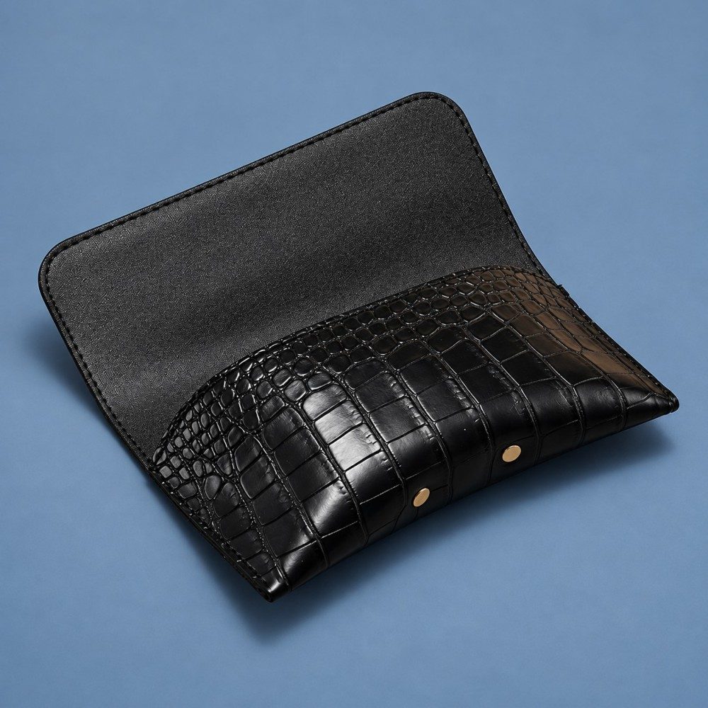 Black glasses case with the flap open, showing the dark inner surface and shaped front pocket