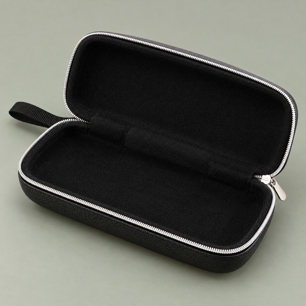 Open rectangular glasses case showing its plain black lined interior, light-colored perimeter zipper, silver-tone pull and black carry loop.