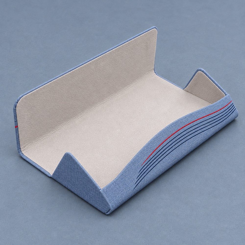 Open blue magnetic glasses case showing light-colored velvet lining, shaped end panels and an undivided interior.