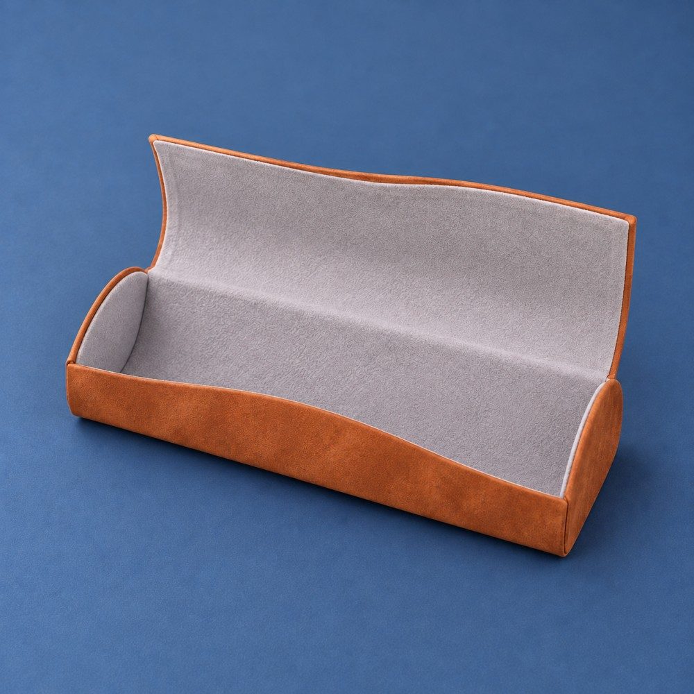 Open brown glasses case showing light gray fine-pile lining, curved end panels and a wide opening.