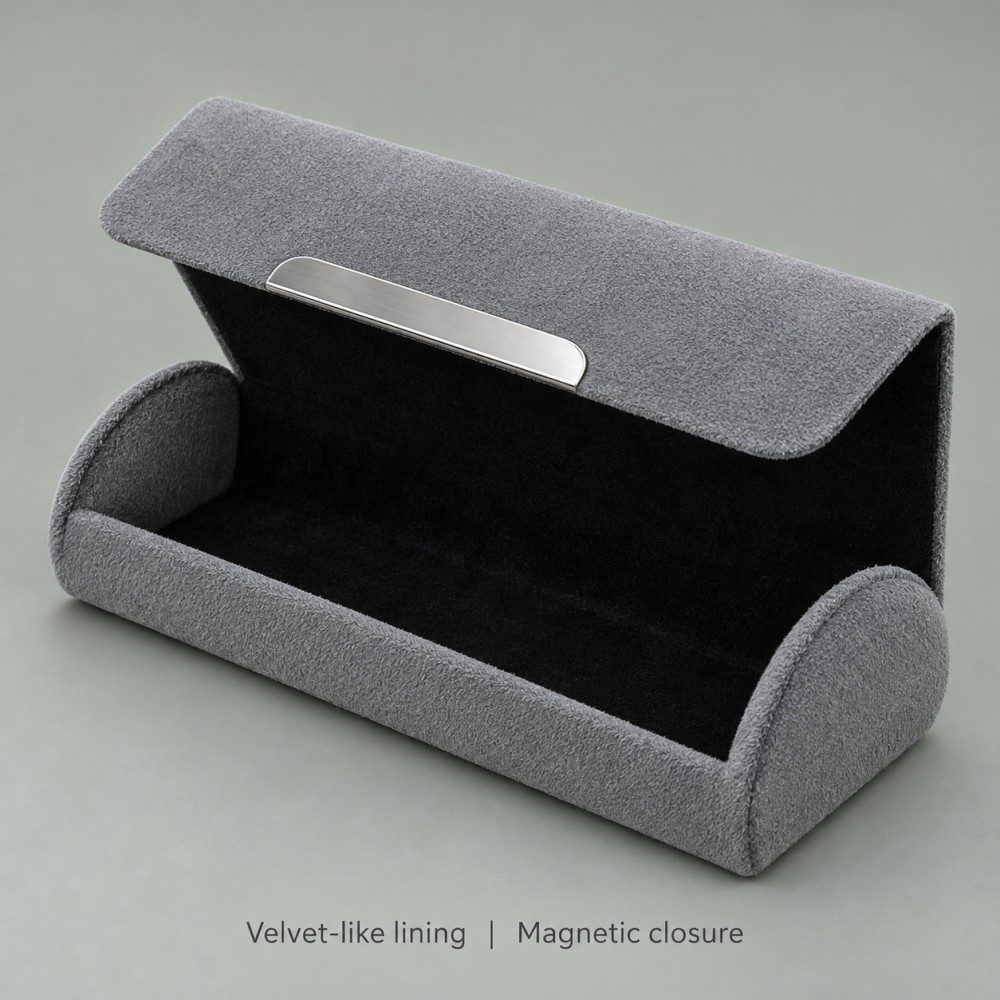 Open gray magnetic sunglasses case showing black velvet-like lining, rounded end panels and silver-colored exterior flap trim.