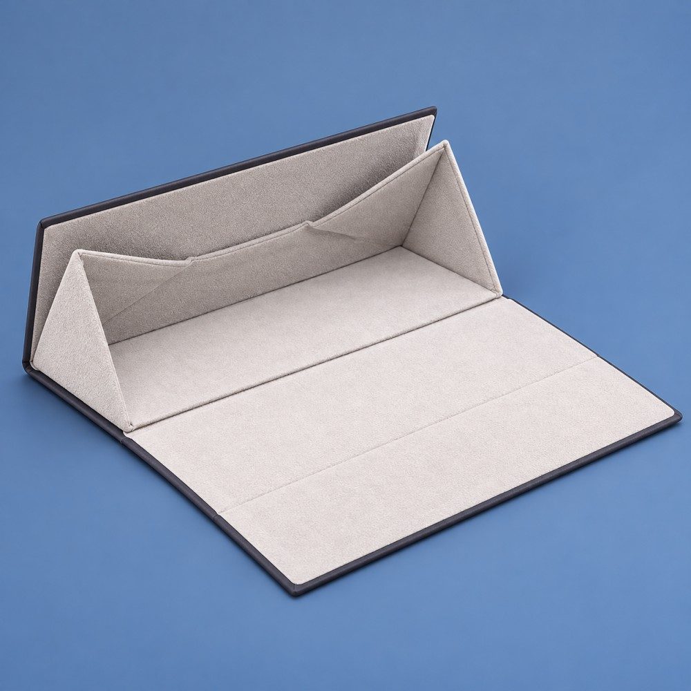 Open magnetic eyeglass case showing light-colored velvet lining, triangular folding sides and a broad front flap.