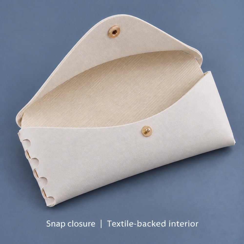 Open white PVC glasses case showing its light textile-backed interior, snap components and hand-laced side.
