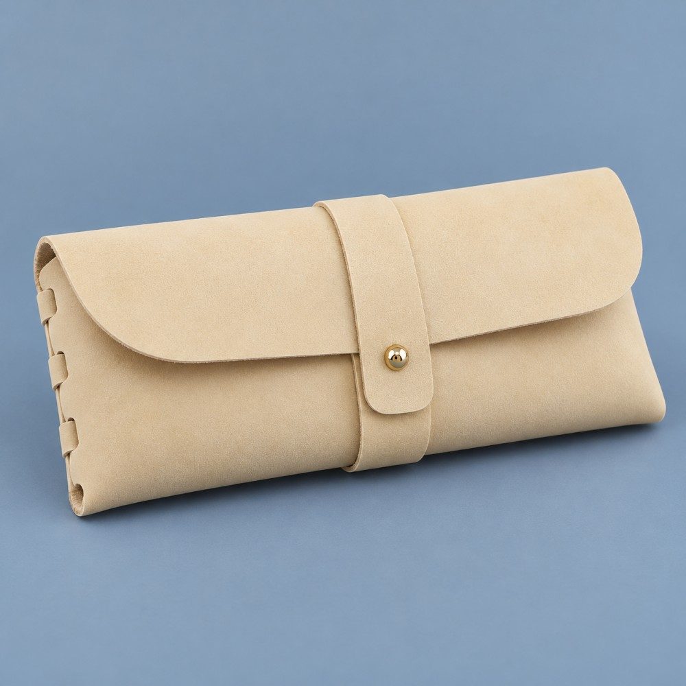 Pale yellow soft eyeglass case with a rounded flap, central wrap strap, gold-tone stud and laced side edge.