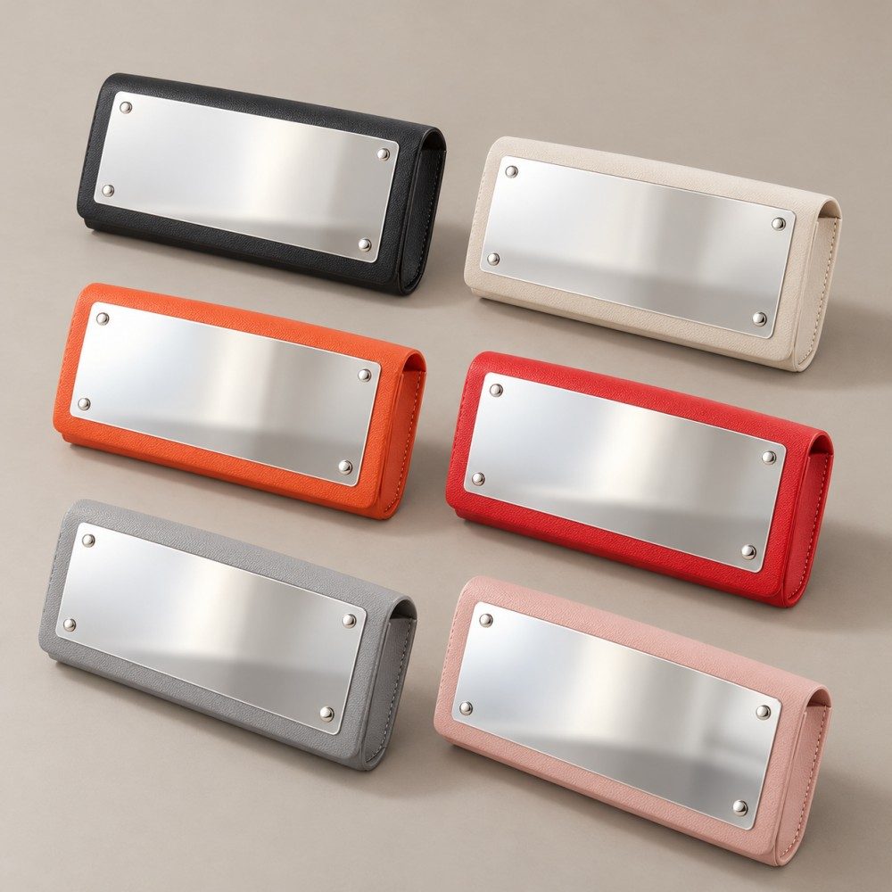 Six PVC glasses cases with exterior mirrors in black, ivory, orange, red, gray and pale pink.