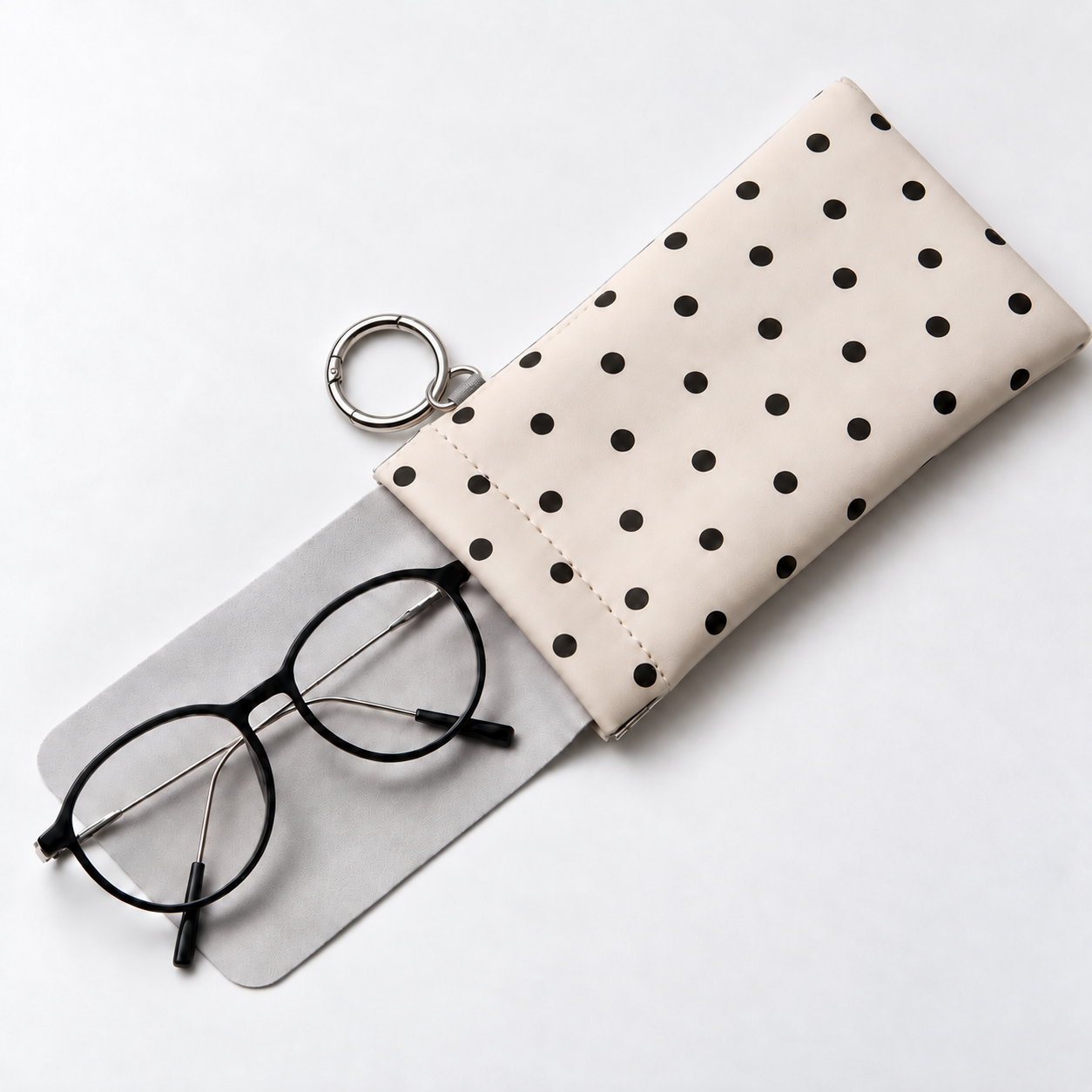 Polka dot eyeglass pouch with an extended built-in cleaning cloth and glasses