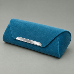 Teal magnetic sunglasses case with a velvet-like surface, rounded end panel and silver-colored trim along the flap.