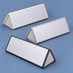 Three silver-effect folding eyeglass cases with black, grey and ivory trim on a blue background.