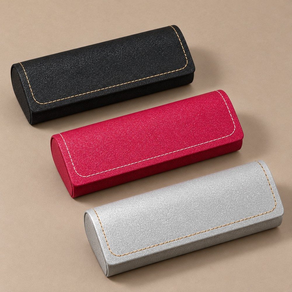 Black, red and silver glasses cases with matching rectangular flaps, contrast stitching and rounded ends.