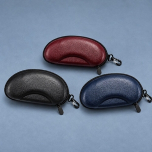 Three matching contoured sunglasses cases in black and illustrative burgundy and navy colorways, with black zippers and swivel clips.